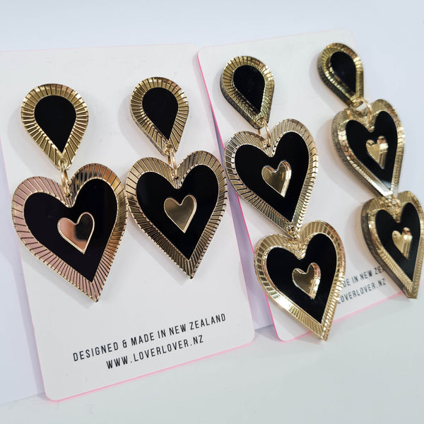 Heart shaped drop statement earring with tear drop top. Gold Etched mirror details. Black and gold in colour.  Available in Single and double drop 